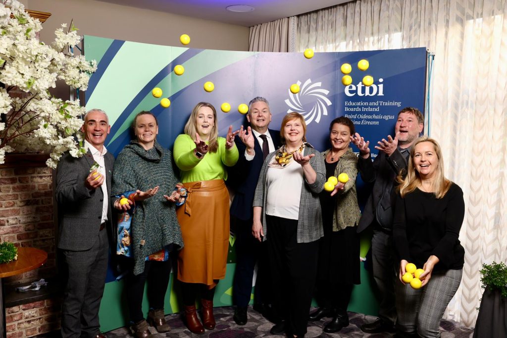 Group of people at FET Euroguidance conference throwing tennis balls into the air